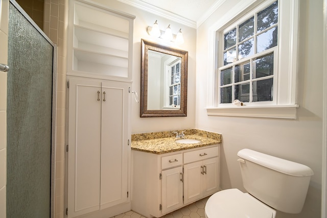 bathroom featuring vanity, toilet, a shower with shower door, and crown molding