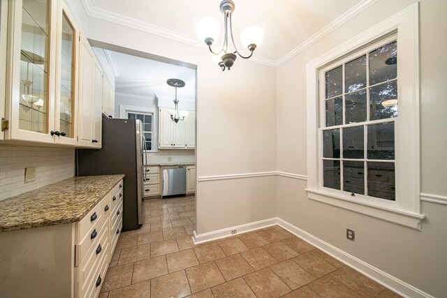 kitchen with white cabinetry, a chandelier, decorative light fixtures, decorative backsplash, and appliances with stainless steel finishes