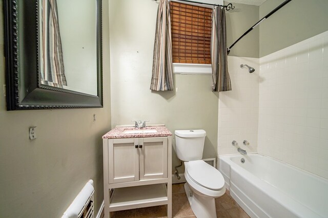 full bathroom featuring tile patterned flooring, vanity, toilet, and tiled shower / bath