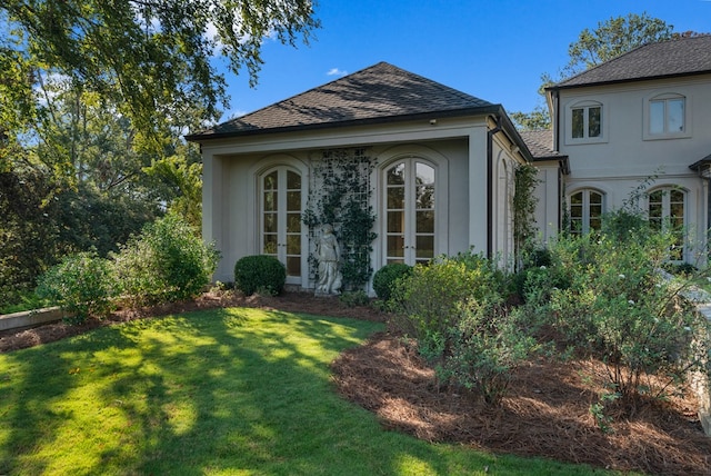 exterior space featuring a lawn and french doors