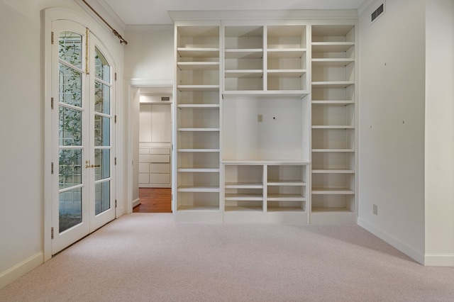 walk in closet featuring french doors and carpet floors