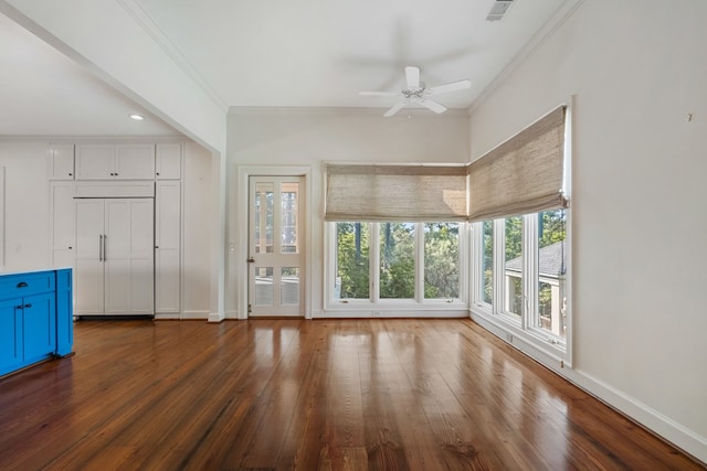 unfurnished living room featuring crown molding, plenty of natural light, ceiling fan, and dark hardwood / wood-style floors