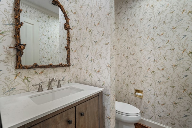 bathroom featuring vanity, toilet, and crown molding