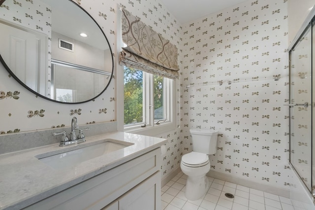 bathroom featuring tile patterned flooring, vanity, and toilet