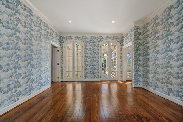 unfurnished room featuring french doors, wood-type flooring, and ornamental molding