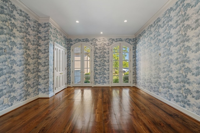 spare room featuring french doors, dark wood-type flooring, and ornamental molding