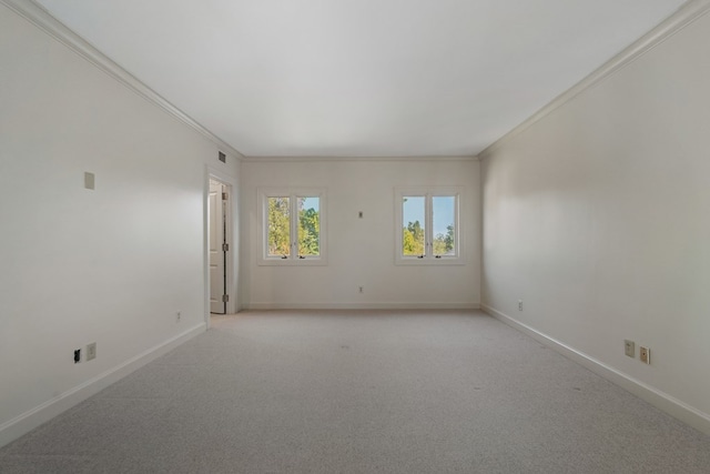 carpeted spare room featuring ornamental molding