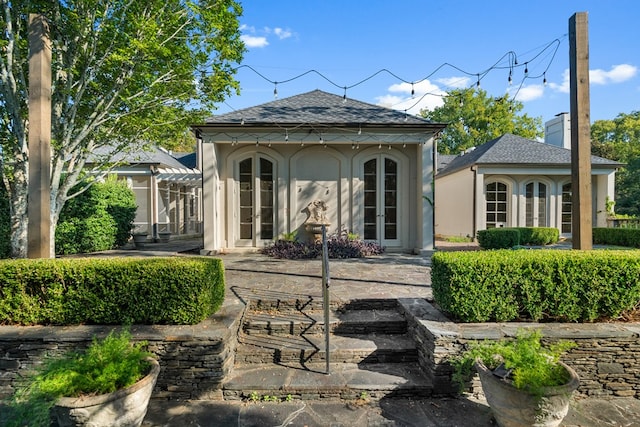 rear view of property featuring french doors