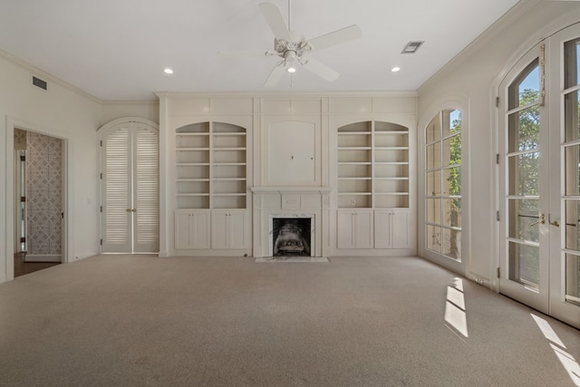 unfurnished living room featuring ceiling fan, french doors, light colored carpet, and ornamental molding