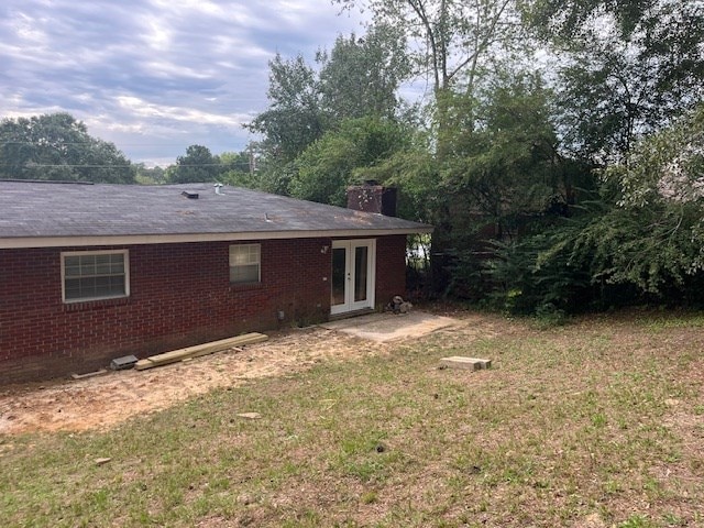 rear view of house with a yard