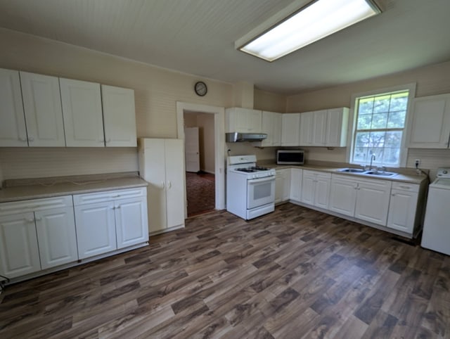 kitchen featuring dark wood-type flooring, white cabinets, sink, white gas range oven, and washer / clothes dryer