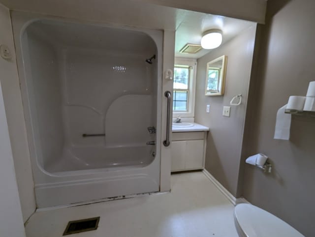 bathroom with vanity, a bathtub, and toilet