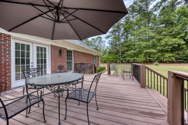 1000 Gramercy Dr, Midland, GA 31820 - deck with outdoor dining area, a lawn, and french doors
