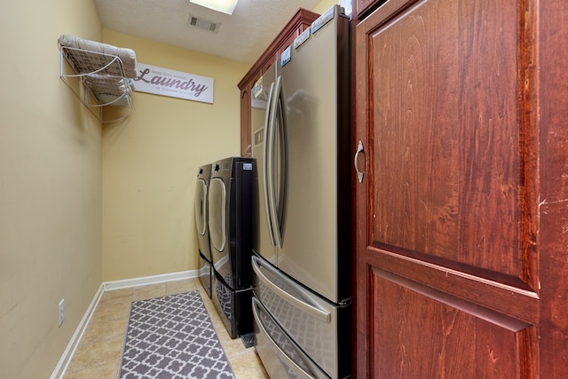 1000 Gramercy Dr, Midland, GA 31820 - laundry room with washing machine and clothes dryer, light tile patterned flooring, and baseboards