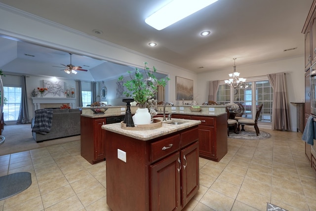 1000 Gramercy Dr, Midland, GA 31820 - kitchen with a kitchen island with sink, a sink, a fireplace, a chandelier, and dark brown cabinets