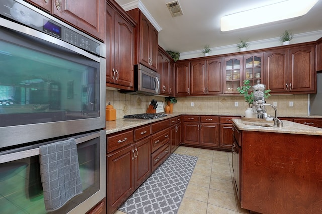 1000 Gramercy Dr, Midland, GA 31820 - kitchen with appliances with stainless steel finishes, a sink, backsplash, light stone countertops, and glass insert cabinets