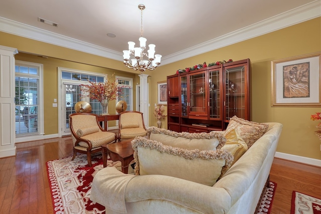1000 Gramercy Dr, Midland, GA 31820 - living room featuring ornate columns, a chandelier, crown molding, wood-type flooring, and baseboards