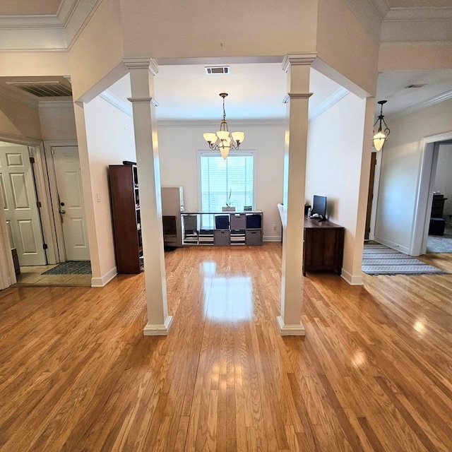 interior space with ornamental molding, light wood-type flooring, visible vents, and decorative columns