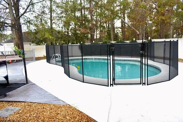 view of pool featuring a patio area, fence, and a fenced in pool