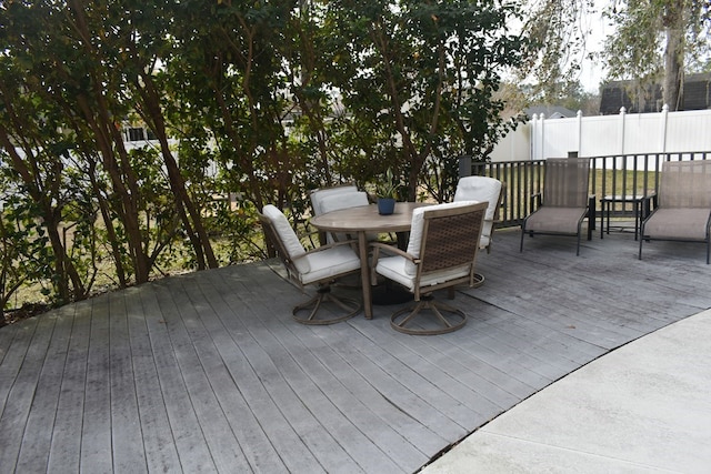 wooden terrace featuring outdoor dining area and fence