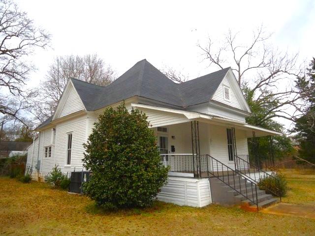 view of side of home featuring covered porch