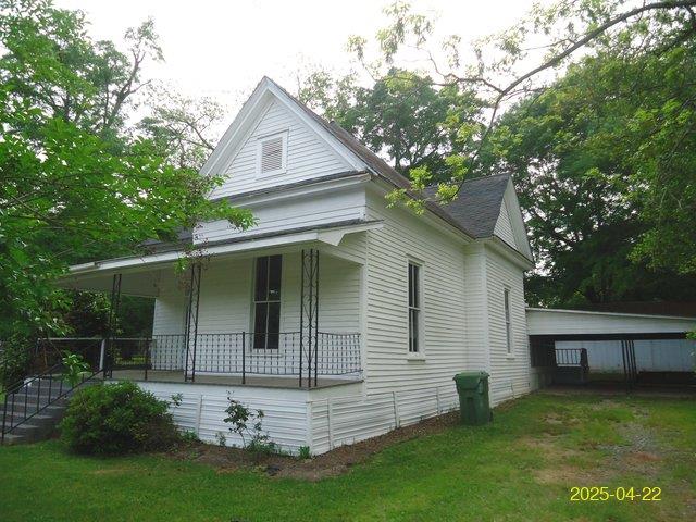 621 Alston St, Richland, GA 31825 - view of home's exterior with covered porch and a yard