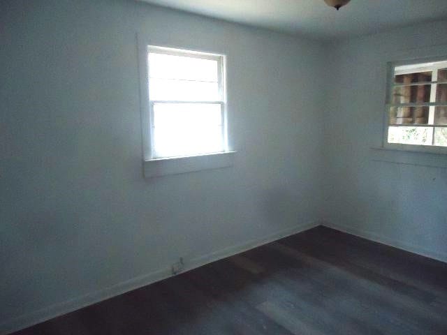 empty room featuring dark wood-type flooring
