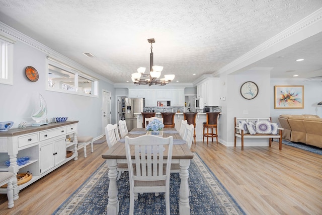 566 Longview Dr, Hamilton, GA 31811 - dining space with a chandelier, light wood finished floors, baseboards, recessed lighting, and a textured ceiling