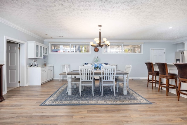 566 Longview Dr, Hamilton, GA 31811 - dining room featuring a chandelier, recessed lighting, light wood-style flooring, a textured ceiling, and ornamental molding