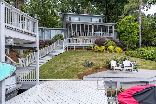 566 Longview Dr, Hamilton, GA 31811 - rear view of house featuring a sunroom, a wooden deck, a chimney, stairway, and a yard