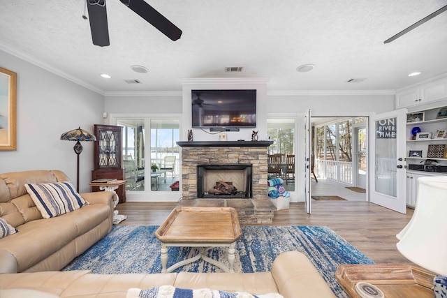 566 Longview Dr, Hamilton, GA 31811 - living area with ceiling fan, wood finished floors, a stone fireplace, ornamental molding, and recessed lighting