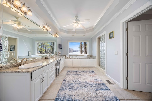 566 Longview Dr, Hamilton, GA 31811 - bathroom featuring a ceiling fan, crown molding, a tray ceiling, tile patterned flooring, and a garden tub