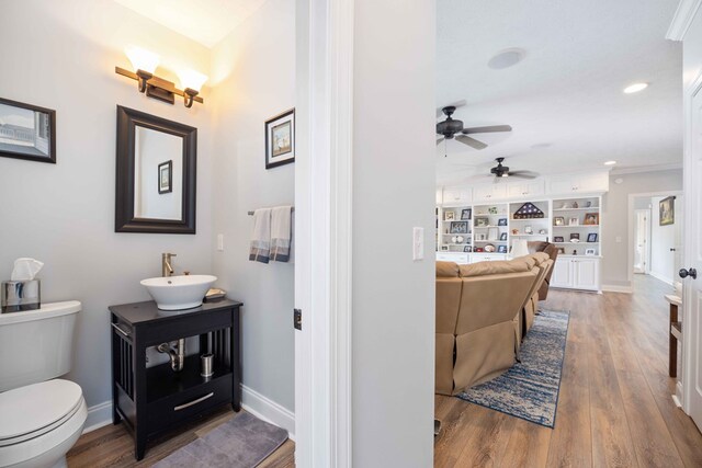 566 Longview Dr, Hamilton, GA 31811 - bathroom featuring ceiling fan, toilet, wood finished floors, vanity, and baseboards