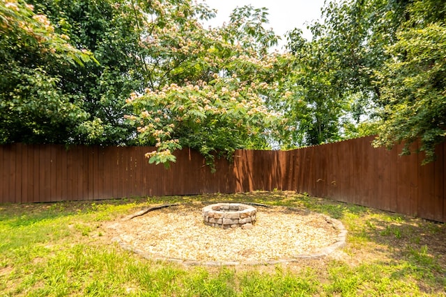 232 Mill Pond Dr, Phenix City, AL 36870 - fenced backyard featuring an outdoor fire pit