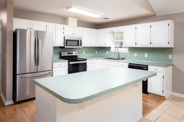 232 Mill Pond Dr, Phenix City, AL 36870 - kitchen with appliances with stainless steel finishes, a sink, white cabinets, and light countertops
