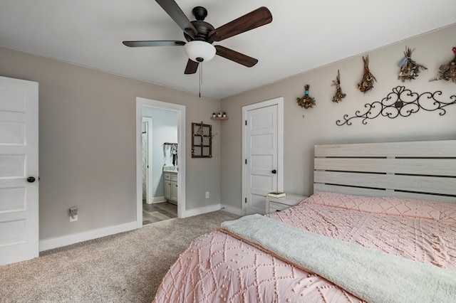 bedroom with ensuite bath, light colored carpet, and ceiling fan