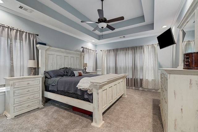 carpeted bedroom with crown molding, a raised ceiling, and ceiling fan