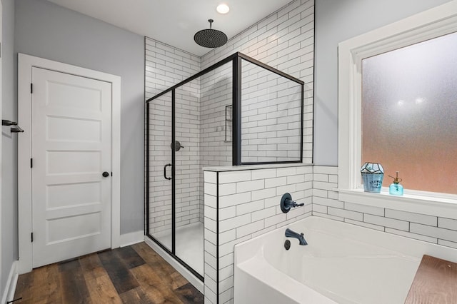 bathroom featuring hardwood / wood-style flooring and shower with separate bathtub