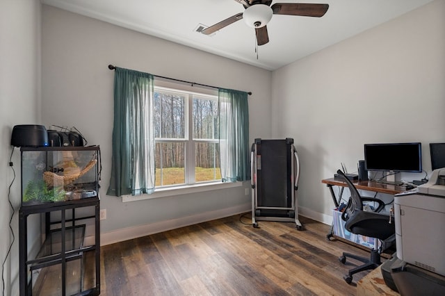 home office with dark hardwood / wood-style floors and ceiling fan