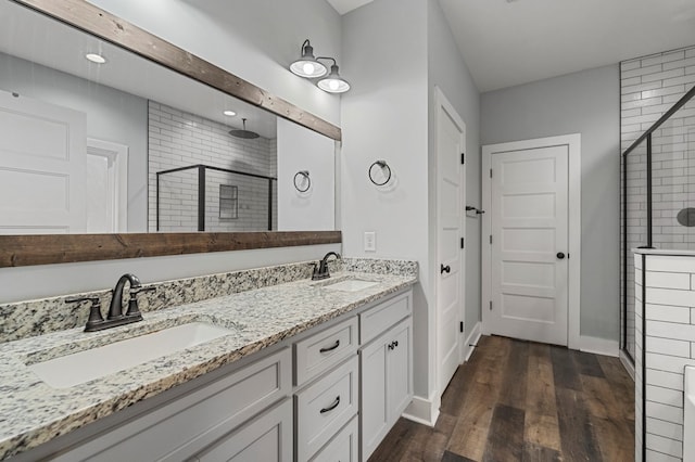 bathroom featuring vanity, a shower with shower door, and hardwood / wood-style floors