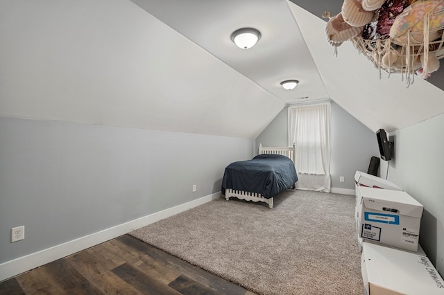 bedroom featuring hardwood / wood-style flooring and vaulted ceiling