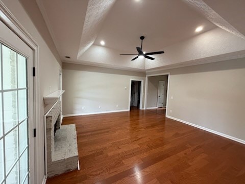 986 Timber Creek Way, Columbus, GA 31904 - unfurnished living room with a raised ceiling, a ceiling fan, a brick fireplace, wood finished floors, and recessed lighting