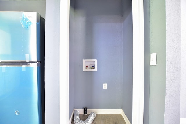 laundry room featuring washer hookup and hardwood / wood-style floors