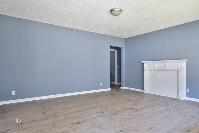 interior space featuring light hardwood / wood-style floors and a textured ceiling