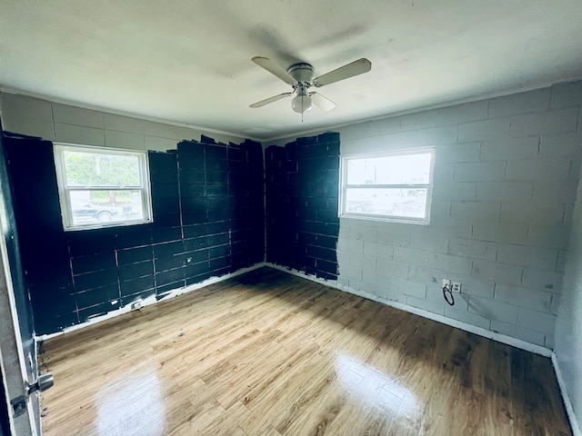 3413 Terminal Ct, Columbus, GA 31906 - empty room featuring wood finished floors, a ceiling fan, plenty of natural light, and concrete block wall