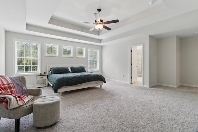 492 Mulberry Crossing Dr, Cataula, GA 31804 - bedroom featuring a tray ceiling, baseboards, light colored carpet, a ceiling fan, and ensuite bathroom