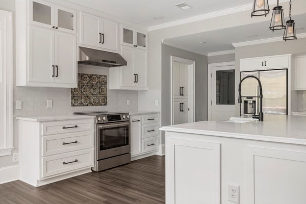 kitchen featuring white cabinetry, dark hardwood / wood-style floors, backsplash, pendant lighting, and appliances with stainless steel finishes