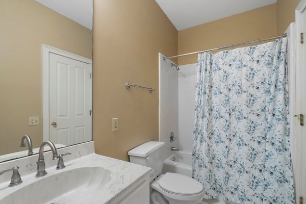 full bathroom with vanity, shower / bath combination with curtain, and toilet