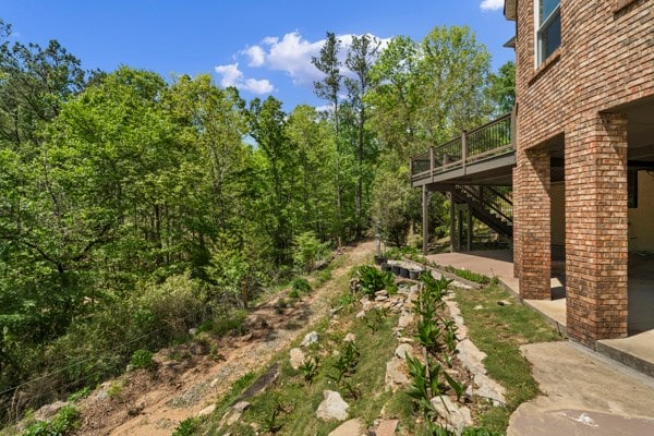 view of yard with a patio and a wooden deck