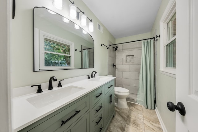 4001 Savannah Dr, Columbus, GA 31907 - full bathroom with marble look tile flooring, double vanity, and tiled shower